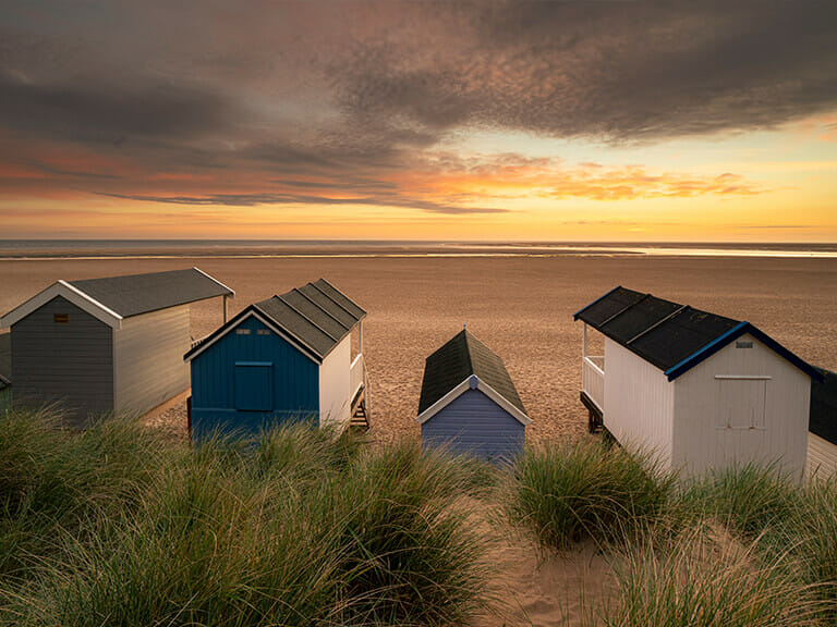 Wells next the Sea beach huts at sunset Fabulous Norfolk